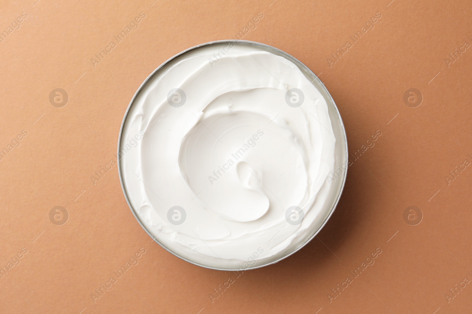 Photo of Jar of face cream on beige background, top view