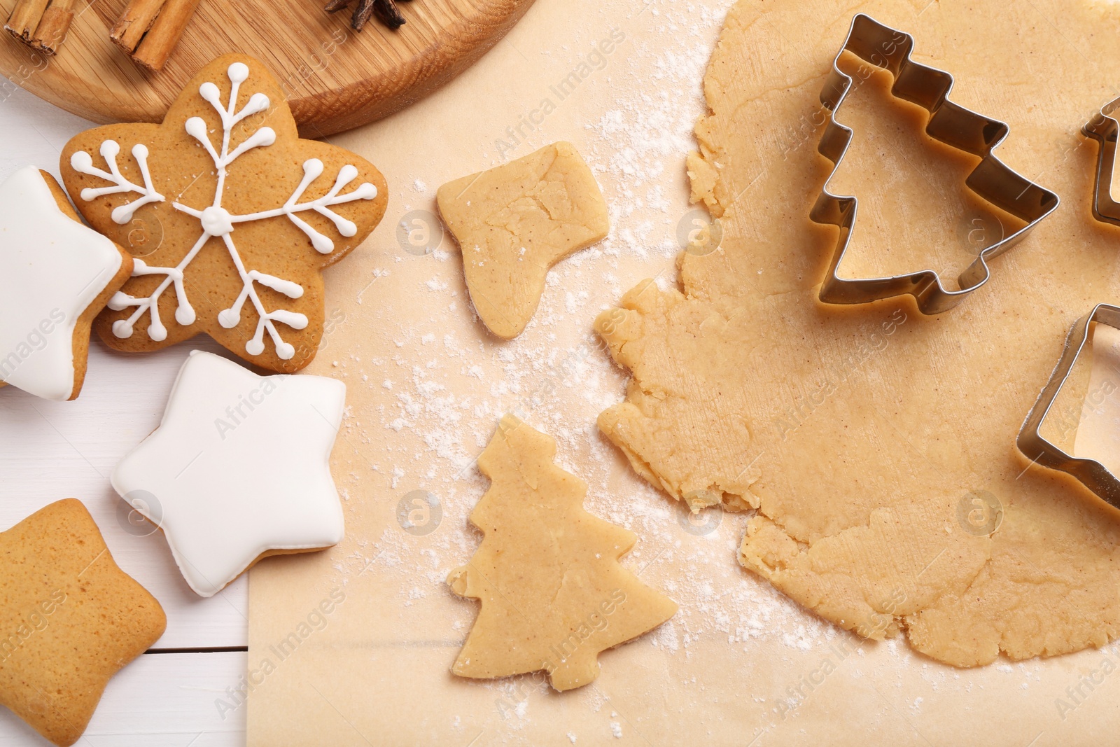 Photo of Making Christmas cookies. Flat lay composition with raw dough on white wooden table