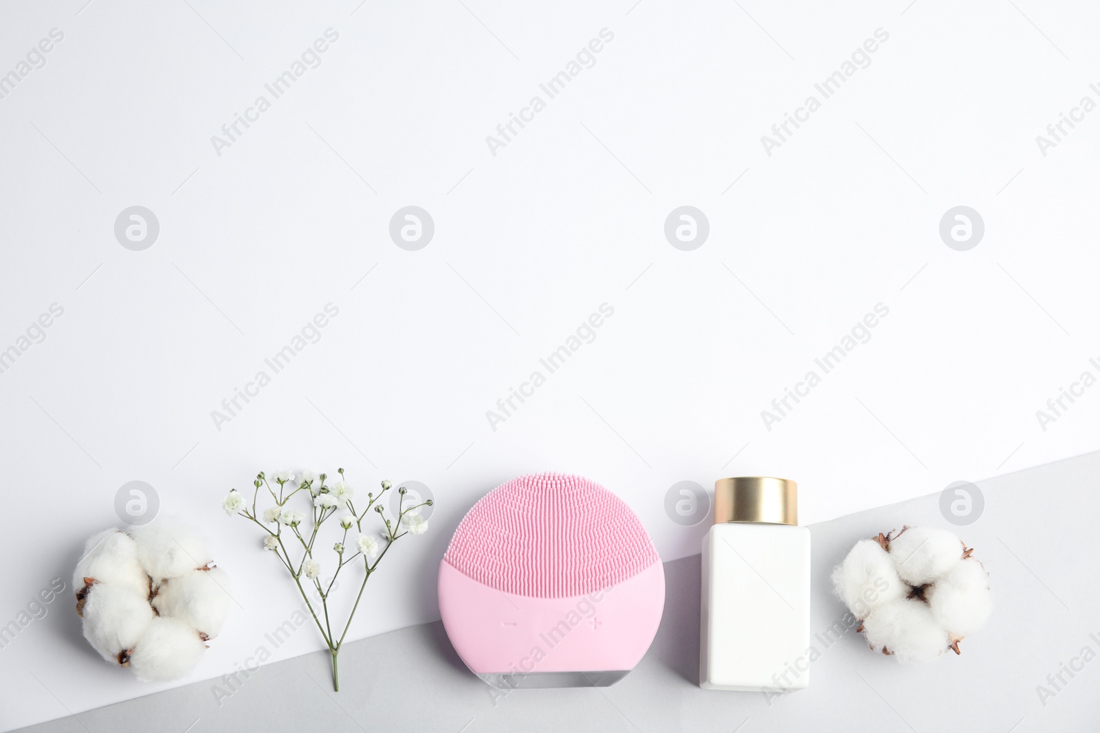 Photo of Flat lay composition with face cleansing brush on color background, space for text. Cosmetic accessory