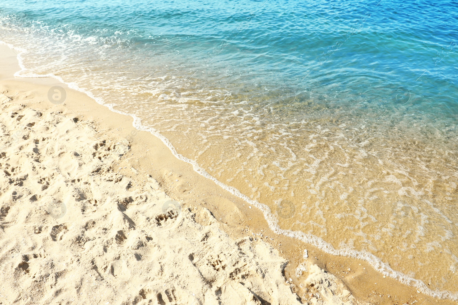 Photo of Sandy beach near sea on sunny day