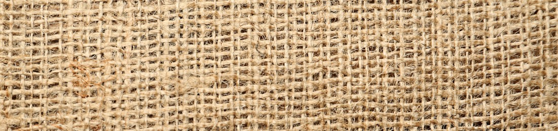 Texture of natural burlap fabric as background, top view. Banner design