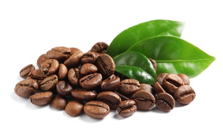 Photo of Roasted coffee beans and fresh green leaves on white background