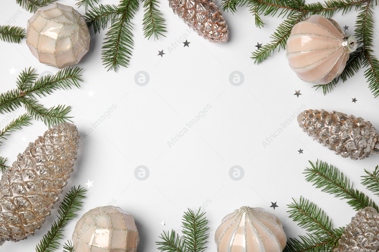 Photo of Christmas greeting card with space for text. Flat lay composition of fir tree branches and festive decor on white background