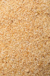 Photo of Aromatic dehydrated garlic granules as background, top view