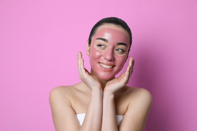 Woman with pomegranate face mask on pink background