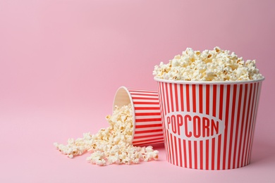 Photo of Fresh popcorn on pink background, space for text. Cinema snack