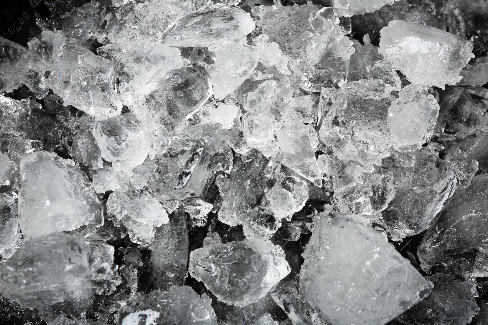 Photo of Crushed ice on black background, top view
