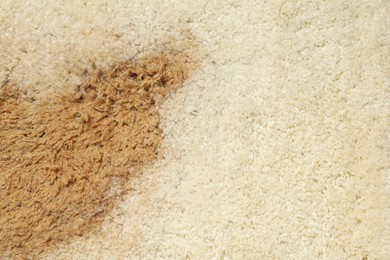Photo of Wet spot on beige carpet as background, top view. Space for text