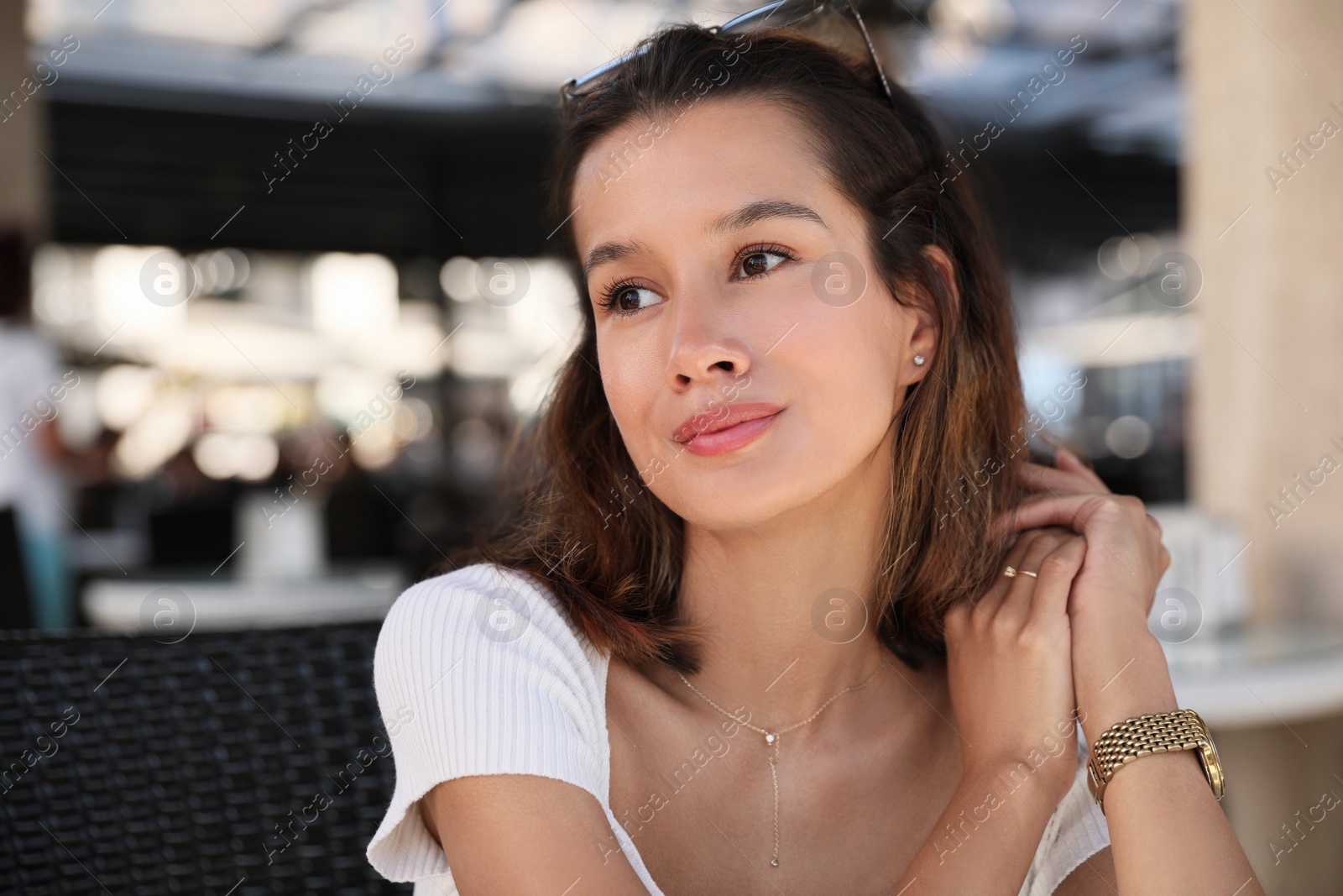 Photo of Portrait of happy young woman in outdoor cafe