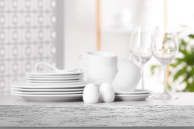 Set of clean dishware, focus on empty stone table