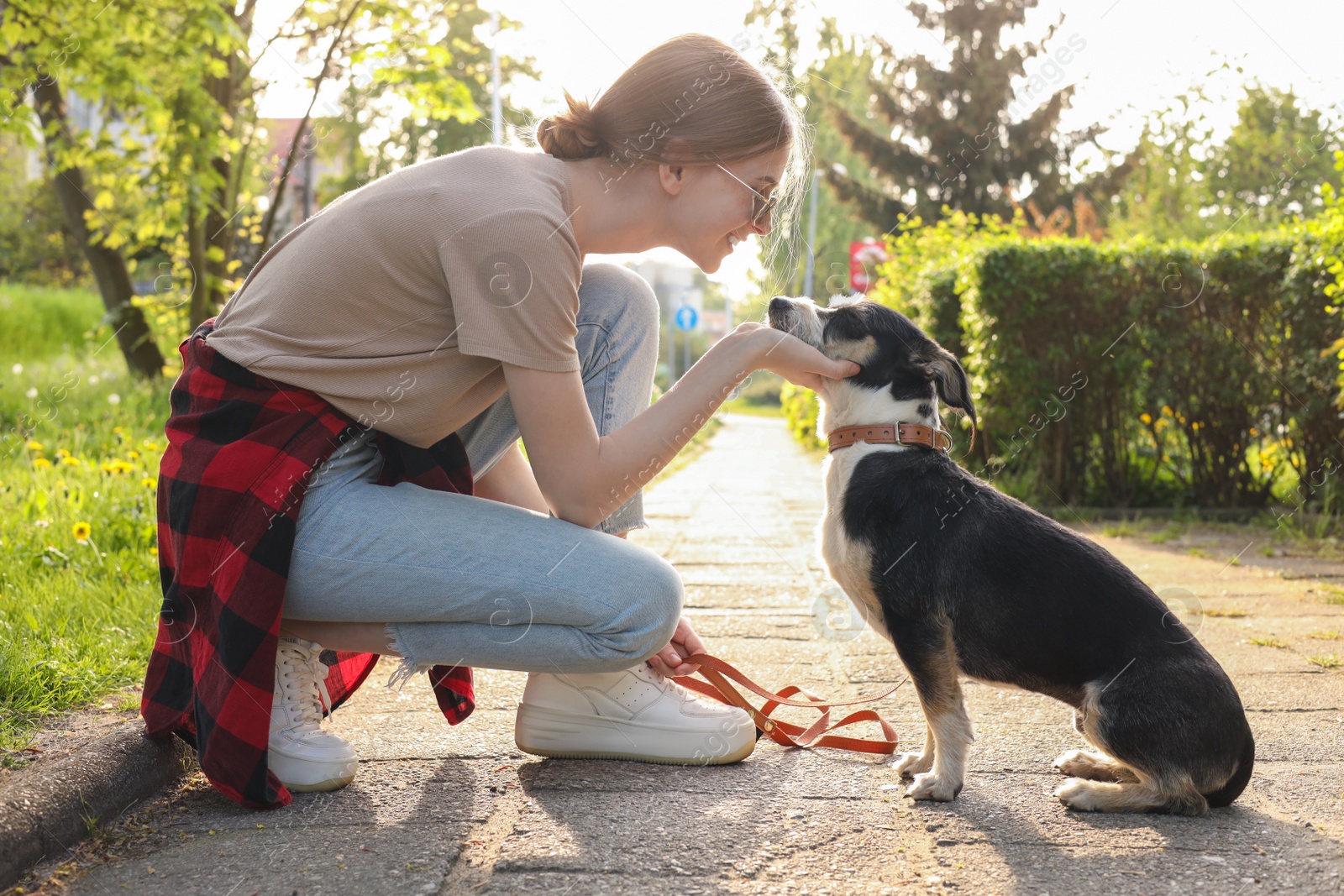 Photo of Teenage girl with her cute dog in park