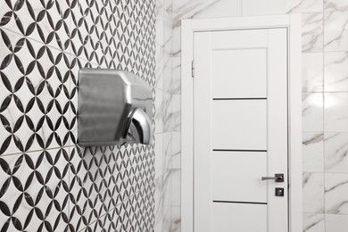 Public toilet interior with stylish white tiles
