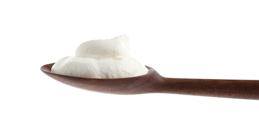 Wooden spoon with sour cream on white background