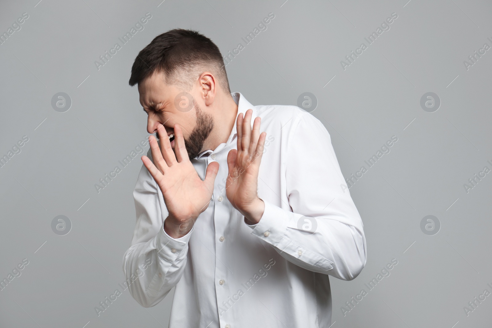 Photo of Portrait of man feeling fear on grey background