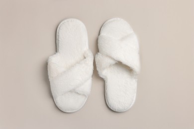 Photo of Pair of soft fluffy slippers on light grey background, top view