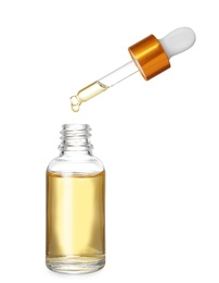 Photo of Bottle and pipette with essential oil on white background