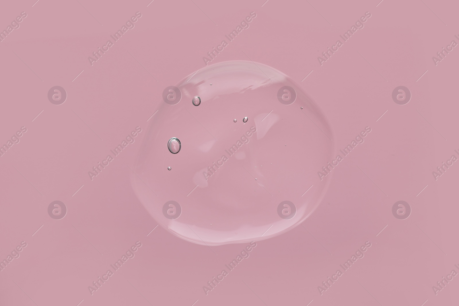 Photo of Sample of cleansing gel on pink background, top view. Cosmetic product