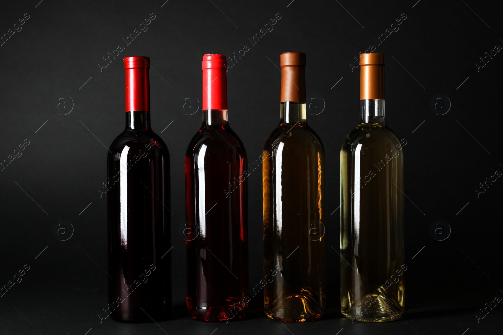 Photo of Bottles of expensive wines on dark background