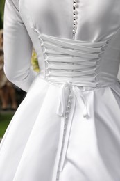 Bride wearing beautiful wedding dress, closeup view