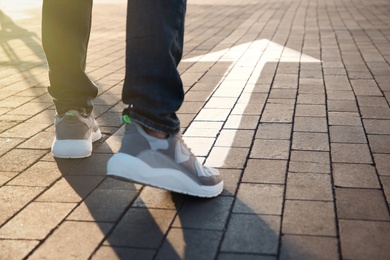 Man going along road with arrow marking, closeup