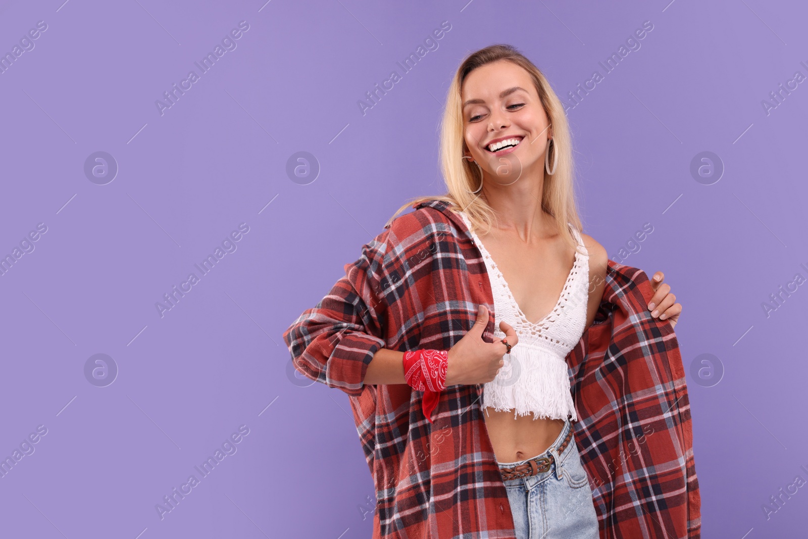 Photo of Portrait of happy hippie woman on purple background. Space for text