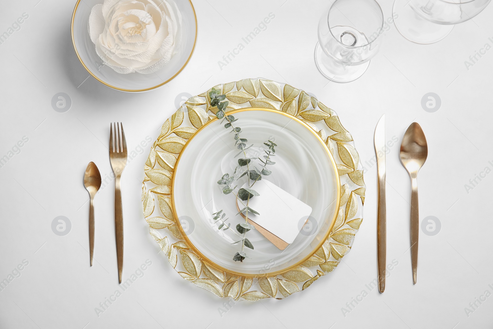 Photo of Elegant table setting on light background, top view