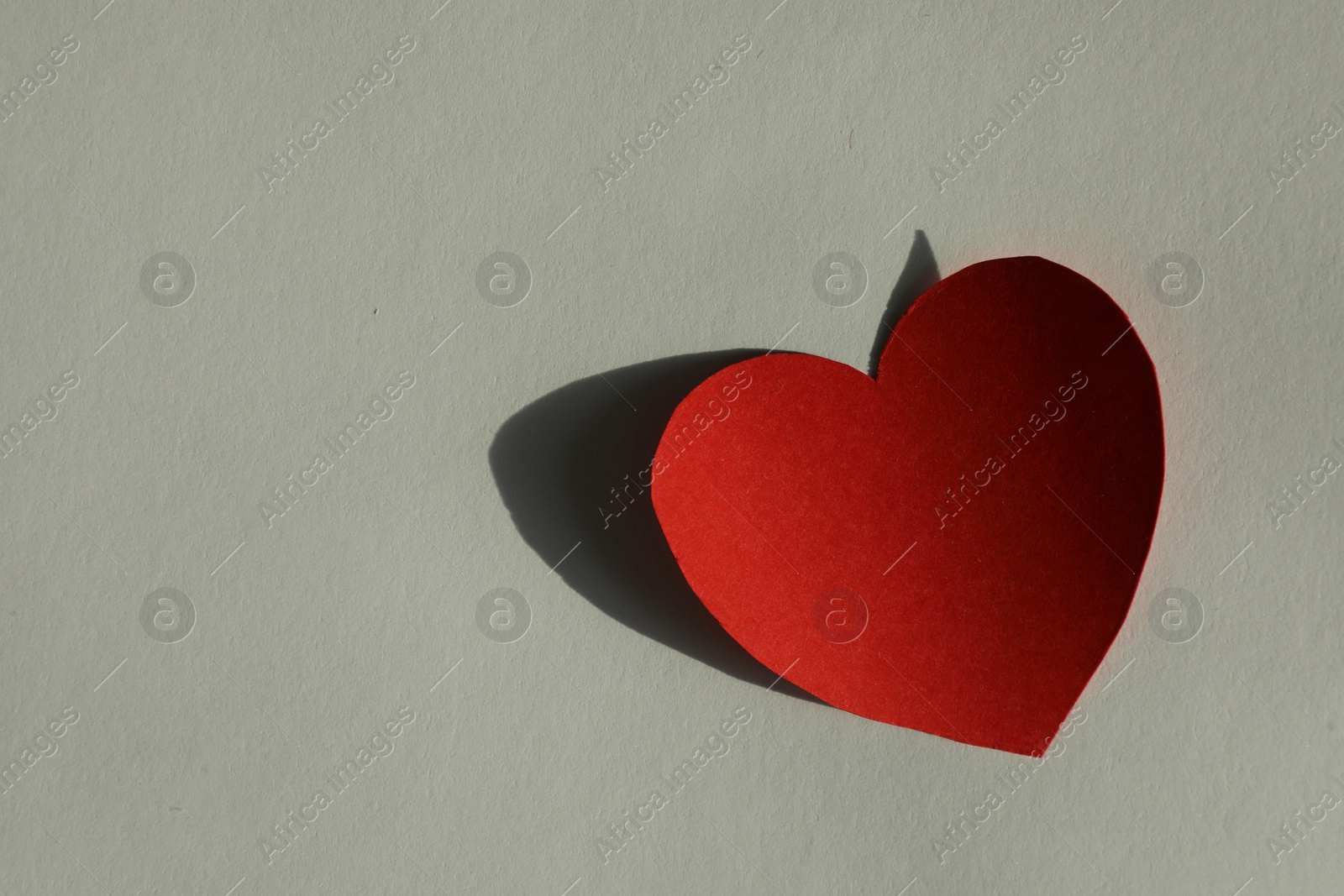 Photo of One paper heart on grey background, top view. Space for text