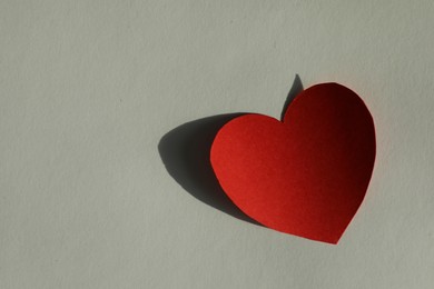 One paper heart on grey background, top view. Space for text