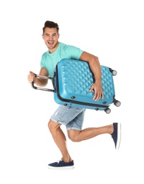 Photo of Young man running with suitcase on white background