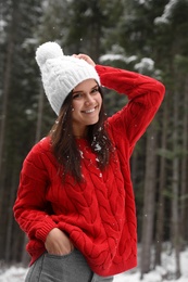Photo of Young woman in warm sweater outdoors on snowy day. Winter vacation