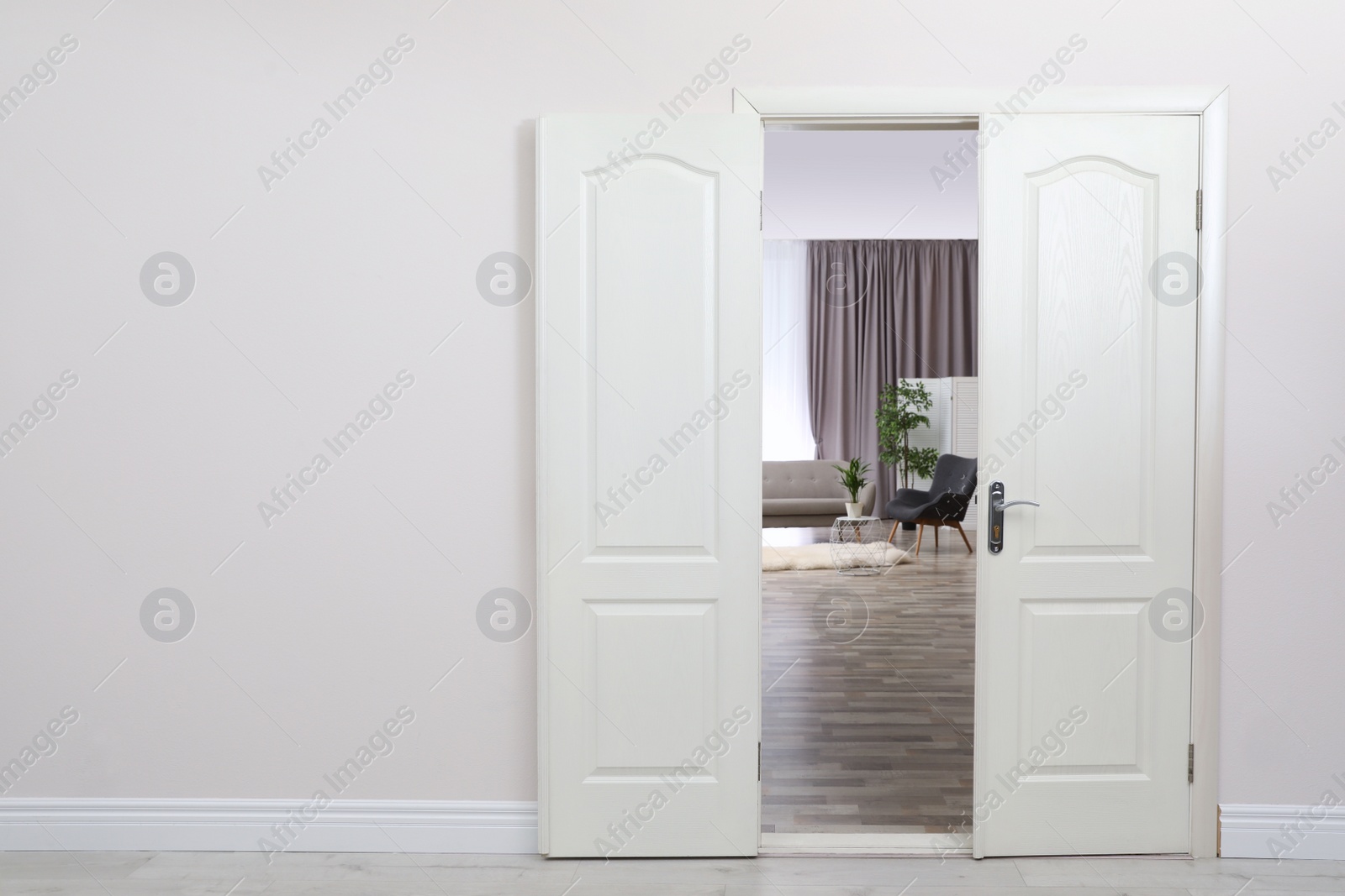 Photo of Stylish room interior, view through open door. Space for text