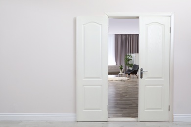 Stylish room interior, view through open door. Space for text