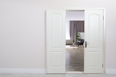 Photo of Stylish room interior, view through open door. Space for text