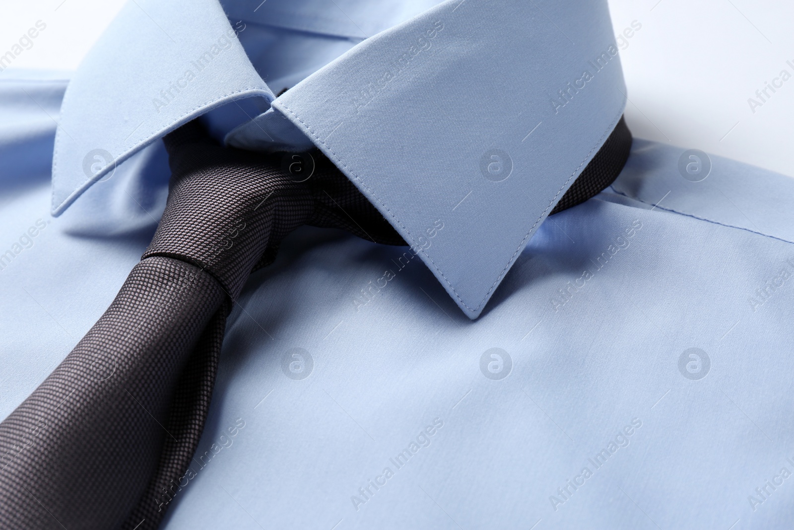 Photo of Color male necktie on blue shirt, closeup. Space for text