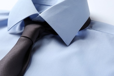 Color male necktie on blue shirt, closeup. Space for text