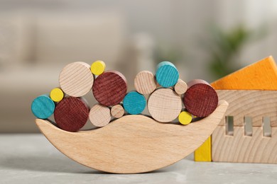 Photo of Wooden balance toy on table indoors, closeup. Children's development