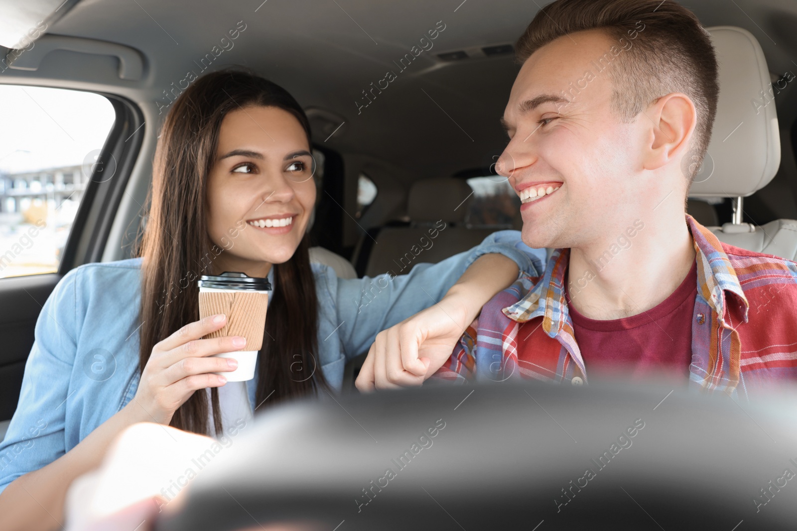 Photo of Happy young couple travelling together by car