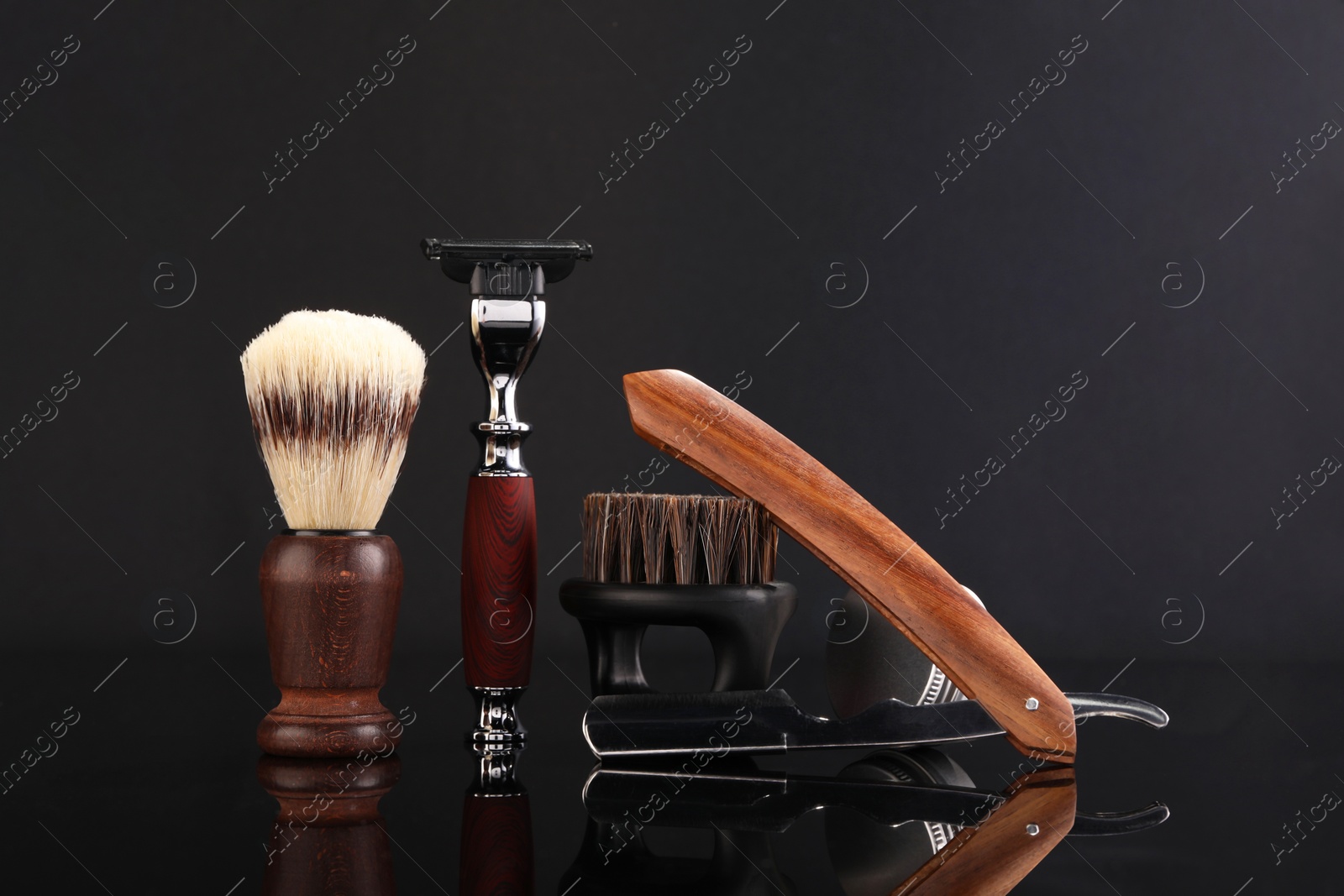 Photo of Moustache and beard styling tools on black mirror surface