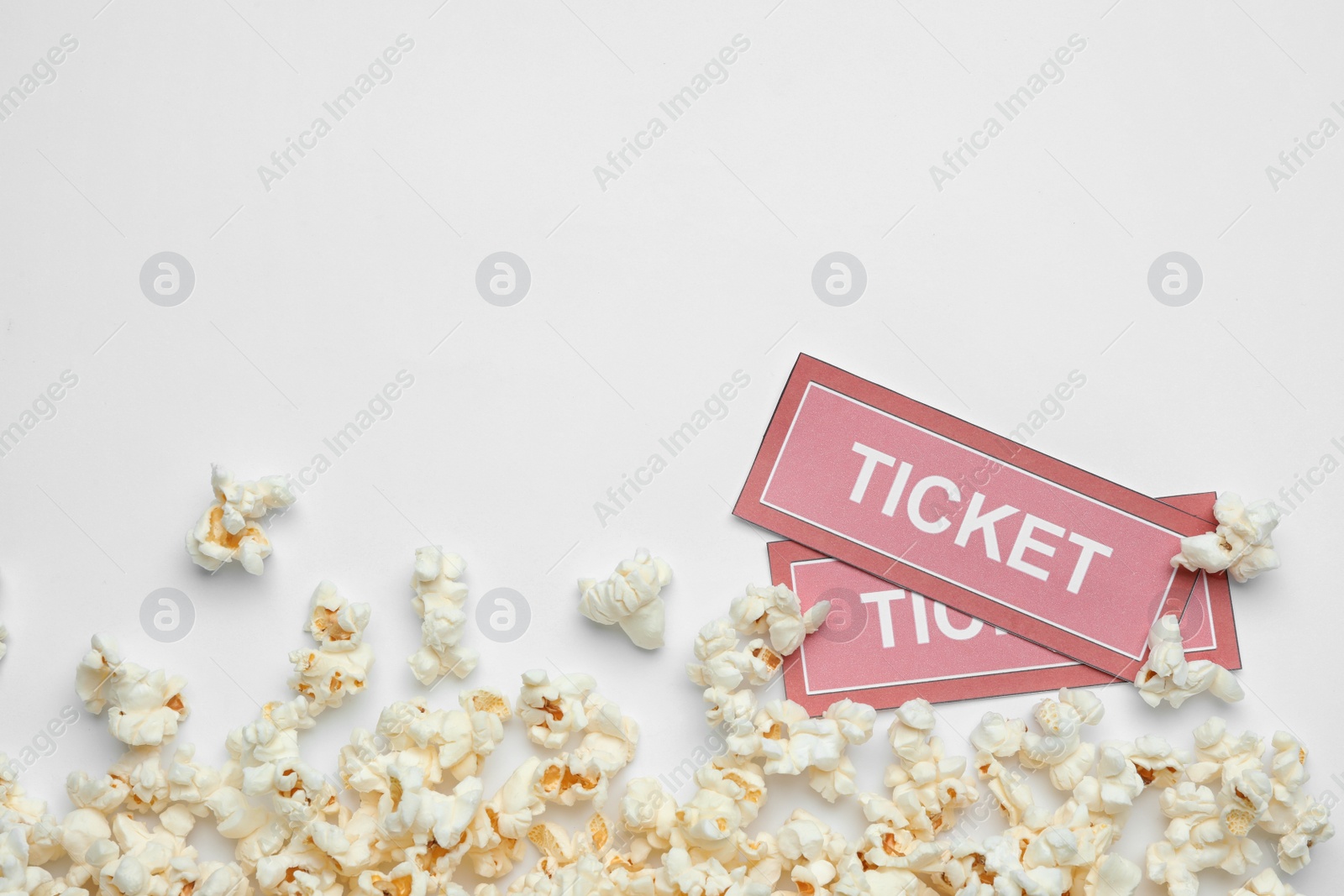 Photo of Popcorn and tickets on white background, top view. Cinema snack