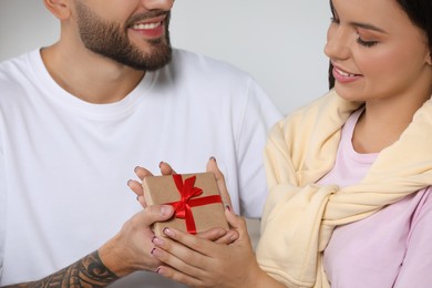 Photo of Lovely couple with beautiful gift, closeup view