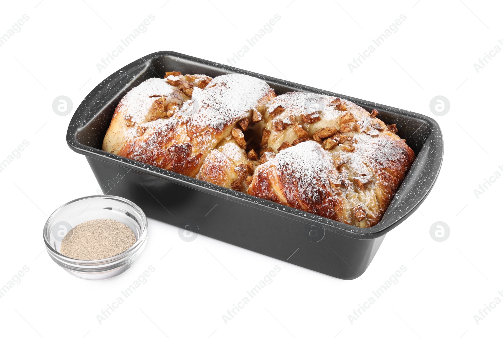 Photo of Delicious cake in baking pan and dry yeast on white background