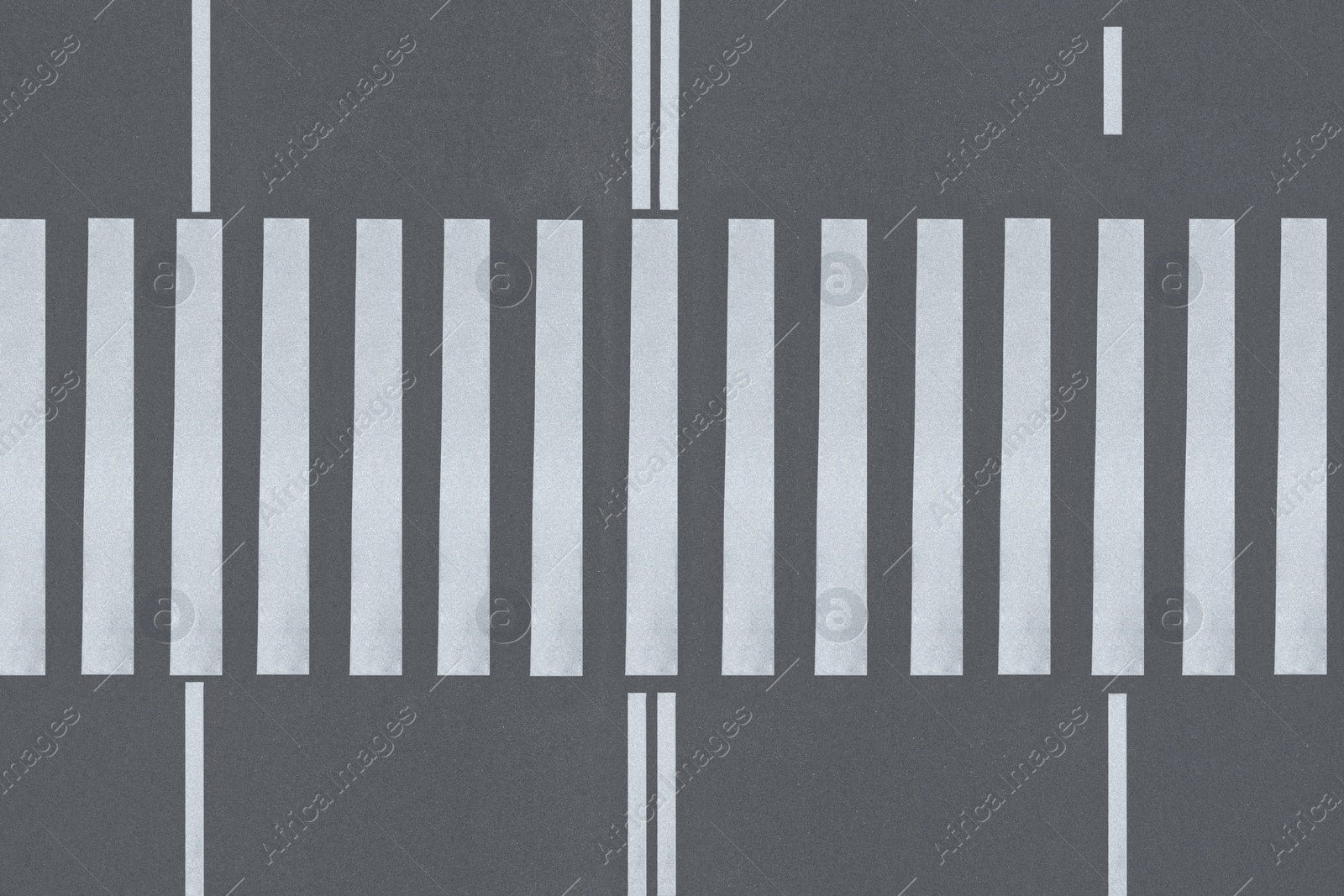 Image of White pedestrian crossing on empty city street, top view