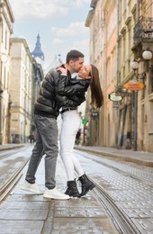 Photo of Lovely young couple walking together on city street. Romantic date