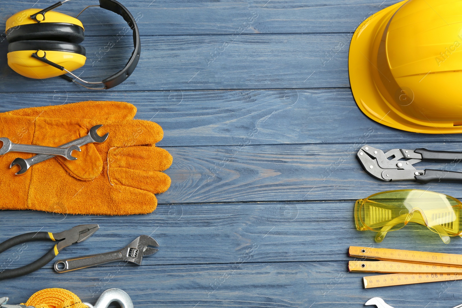 Photo of Flat lay composition with different construction tools and space for text on color wooden background