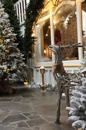 Beautiful Christmas trees, deer and other festive decor indoors. Interior design