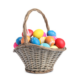 Photo of Basket with colorful Easter eggs isolated on white