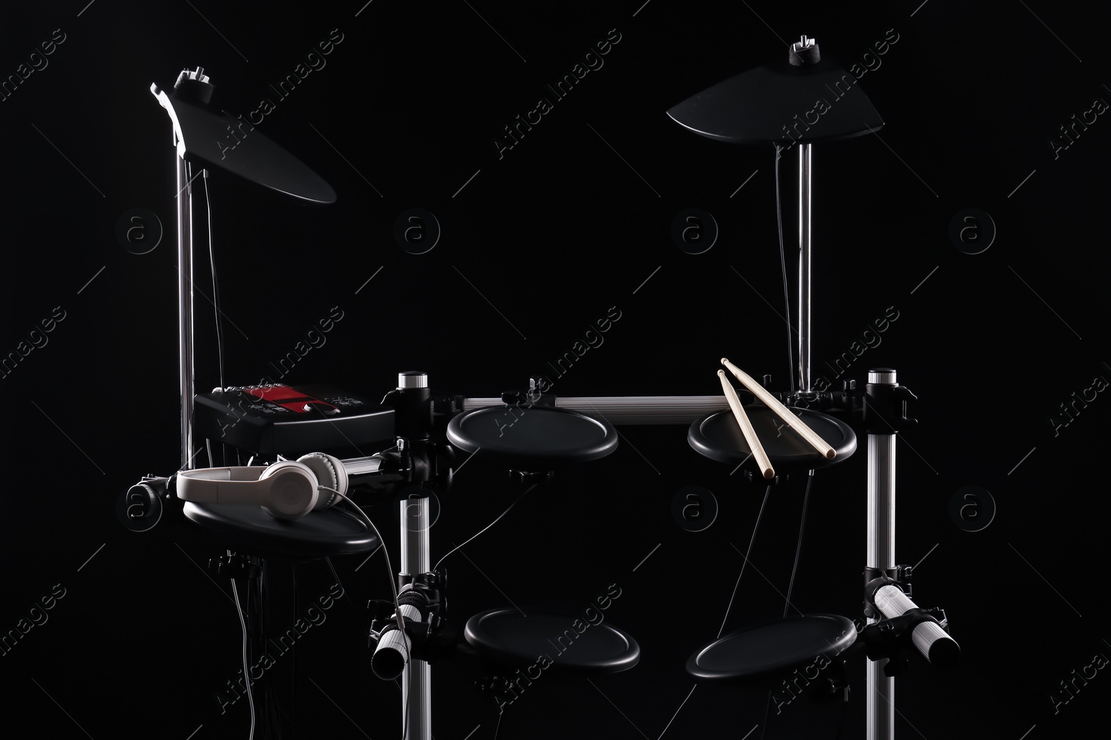 Photo of Modern electronic drum kit on dark background. Musical instrument