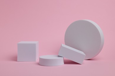 Photo of Scene for product presentation. Podiums of different geometric shapes on pink background