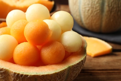 Different melon balls on wooden table, closeup