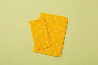 Photo of Beeswax food wraps on light green background, flat lay